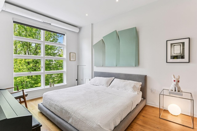 2845 Colfax Ave S Unit W305, Minneapolis, MN 55408 - bedroom featuring multiple windows, wood finished floors, and recessed lighting