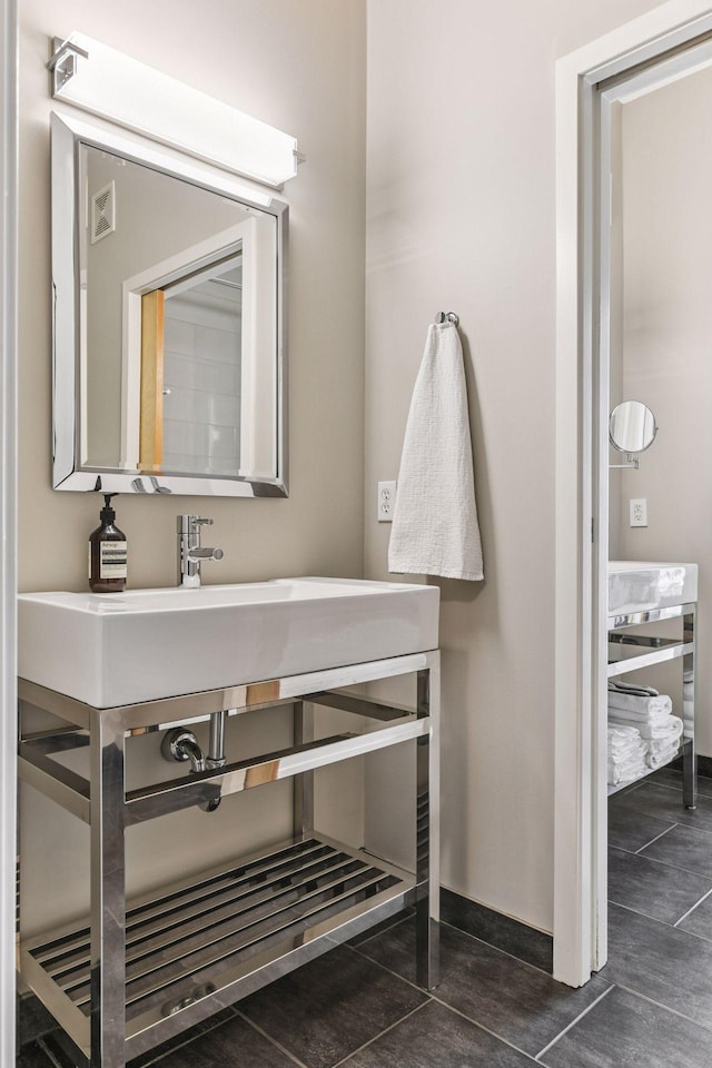 2845 Colfax Ave S Unit W305, Minneapolis, MN 55408 - bathroom with baseboards and tile patterned flooring