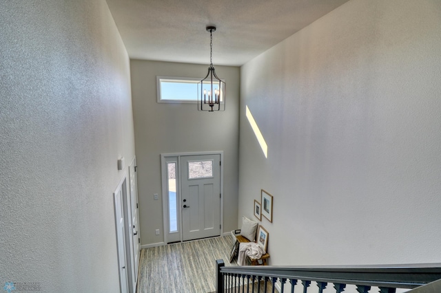 6242 87th Ave S, Horace, ND 58047 - carpeted foyer entrance featuring a high ceiling, a chandelier, baseboards, and a textured wall