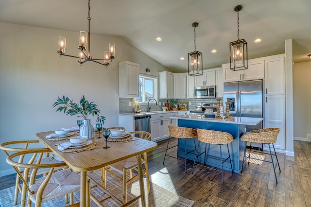 6242 87th Ave S, Horace, ND 58047 - kitchen featuring appliances with stainless steel finishes, a sink, light countertops, decorative backsplash, and lofted ceiling