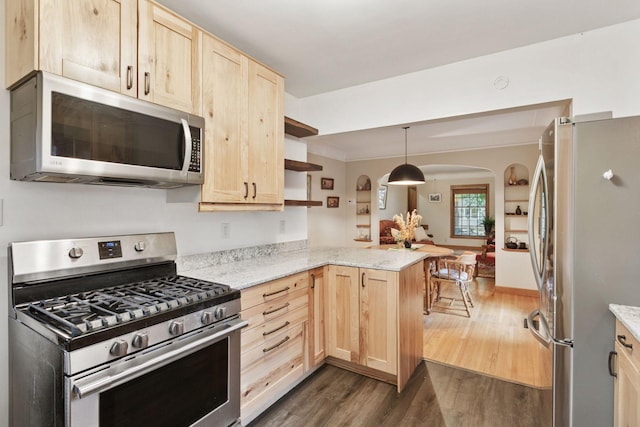 3527 Queen Ave N, Minneapolis, MN 55412 - kitchen featuring stainless steel appliances, light brown cabinetry, arched walkways, a peninsula, and dark wood-style floors