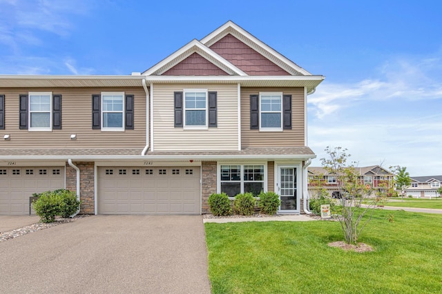 7243 Fall Dr, Lino Lakes, MN 55038 - view of property featuring driveway, a front yard, a garage, and stone siding