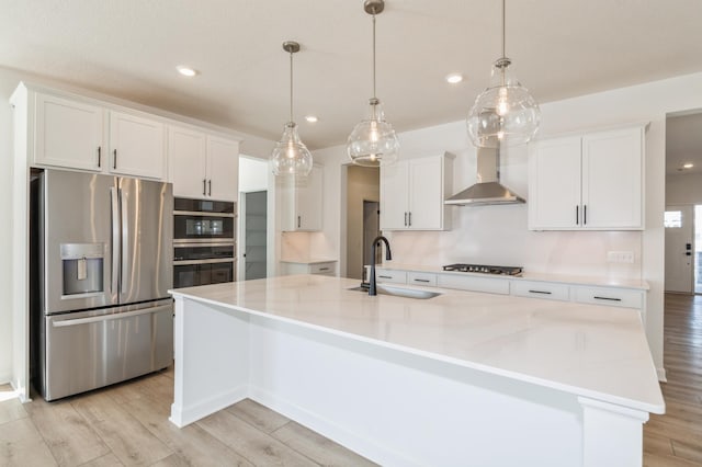 11444 Fieldstone Dr, Rogers, MN 55311 - kitchen featuring appliances with stainless steel finishes, a sink, wall chimney range hood, white cabinetry, and recessed lighting