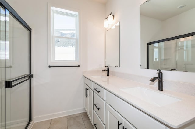 11444 Fieldstone Dr, Rogers, MN 55311 - full bath featuring baseboards, a shower with shower door, double vanity, and tile patterned flooring