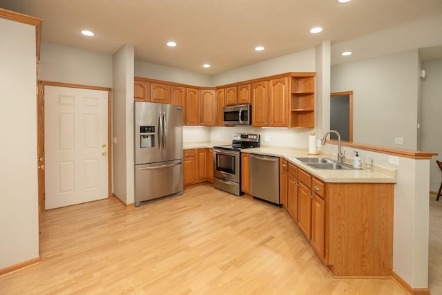 2804 Viola Heights Dr NE, Rochester, MN 55906 - kitchen featuring stainless steel appliances, a sink, a peninsula, open shelves, and light wood-style flooring