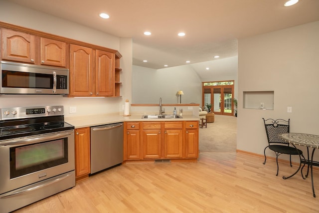 2804 Viola Heights Dr NE, Rochester, MN 55906 - kitchen featuring appliances with stainless steel finishes, a sink, a peninsula, light wood finished floors, and recessed lighting