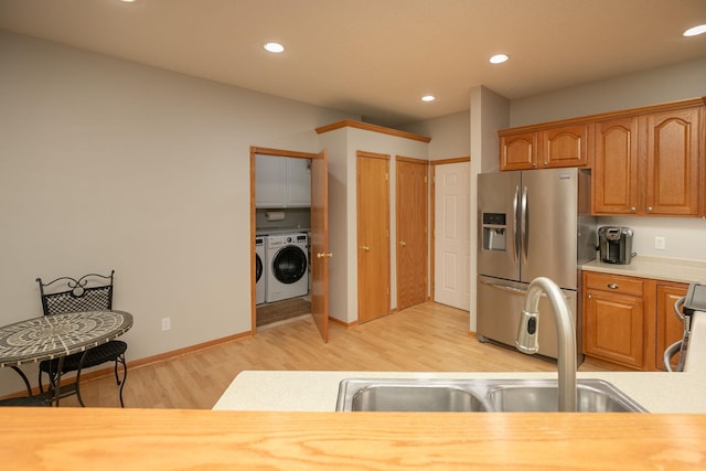2804 Viola Heights Dr NE, Rochester, MN 55906 - kitchen with stainless steel refrigerator with ice dispenser, separate washer and dryer, light countertops, light wood-type flooring, and recessed lighting