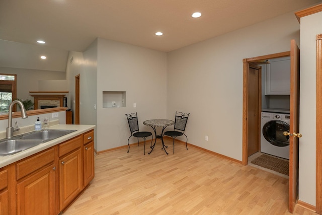 2804 Viola Heights Dr NE, Rochester, MN 55906 - kitchen with washer / dryer, a sink, light wood-type flooring, recessed lighting, and light countertops