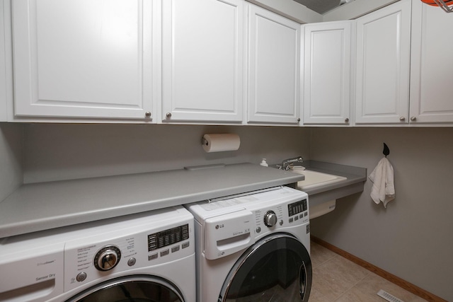 2804 Viola Heights Dr NE, Rochester, MN 55906 - laundry room featuring washer and clothes dryer, cabinet space, baseboards, and light tile patterned floors