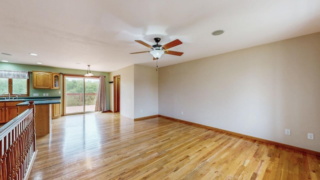 1364 Lone Stone Ct SE, Chatfield, MN 55923 - unfurnished living room with a sink, light wood-style floors, ceiling fan, baseboards, and recessed lighting