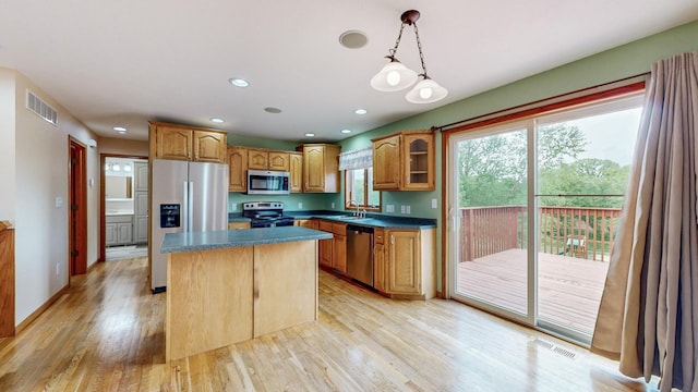 1364 Lone Stone Ct SE, Chatfield, MN 55923 - kitchen with appliances with stainless steel finishes, a center island, light wood-style floors, pendant lighting, and a sink