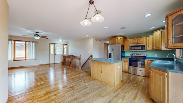 1364 Lone Stone Ct SE, Chatfield, MN 55923 - kitchen with appliances with stainless steel finishes, a sink, a center island, light wood-style floors, and ceiling fan