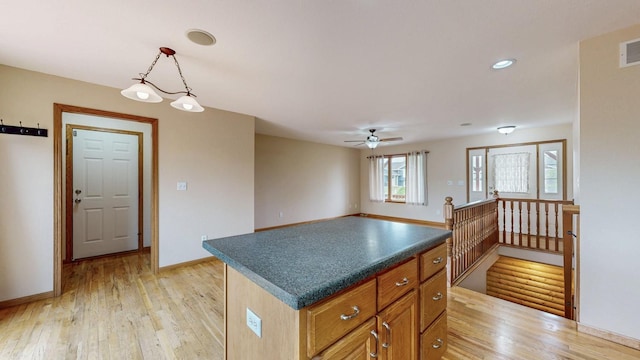 1364 Lone Stone Ct SE, Chatfield, MN 55923 - kitchen featuring light wood finished floors, dark countertops, baseboards, a ceiling fan, and hanging light fixtures