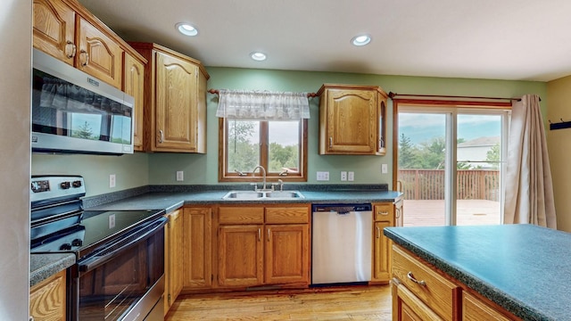 1364 Lone Stone Ct SE, Chatfield, MN 55923 - kitchen with stainless steel appliances, a sink, plenty of natural light, dark countertops, and recessed lighting