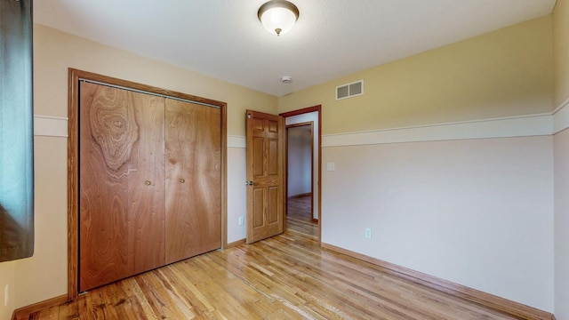 1364 Lone Stone Ct SE, Chatfield, MN 55923 - unfurnished bedroom with light wood-style floors, a closet, and baseboards
