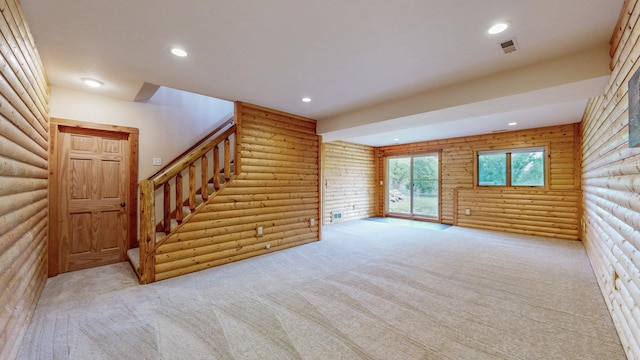 1364 Lone Stone Ct SE, Chatfield, MN 55923 - unfurnished living room with log walls, stairs, carpet floors, and recessed lighting