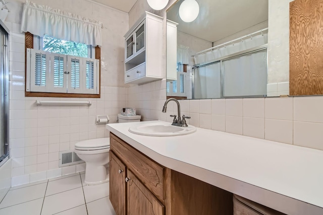 full bath with a shower with door, tile patterned floors, vanity, toilet, and decorative backsplash