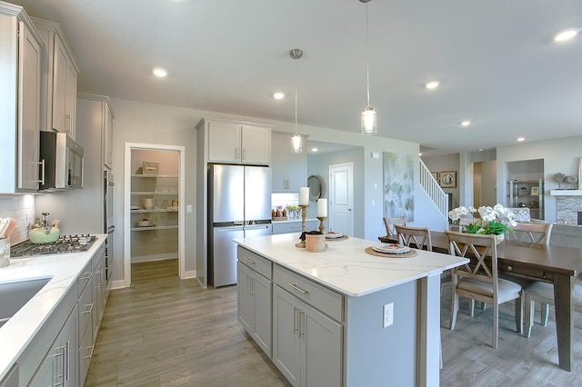 890 Laurel Ct, Chaska, MN 55318 - kitchen with stainless steel appliances, light wood-type flooring, a center island, gray cabinets, and recessed lighting