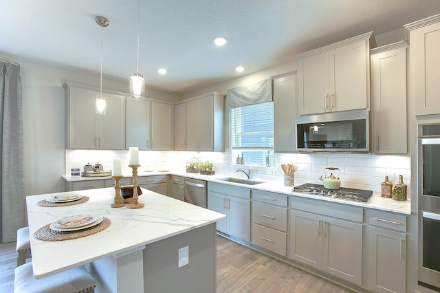 890 Laurel Ct, Chaska, MN 55318 - kitchen featuring appliances with stainless steel finishes, a sink, recessed lighting, decorative backsplash, and light wood finished floors