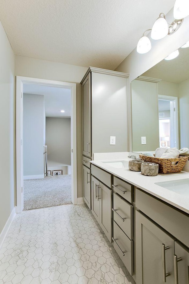 890 Laurel Ct, Chaska, MN 55318 - full bathroom with double vanity, baseboards, and a textured ceiling