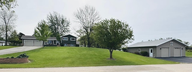 701 Mill St, Fertile, MN 56540 - tri-level home featuring a front lawn, a garage, and an outdoor structure