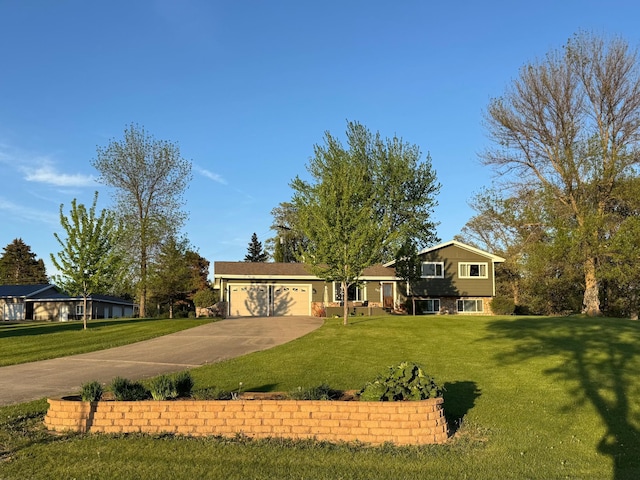 701 Mill St, Fertile, MN 56540 - split level home featuring driveway, an attached garage, and a front yard