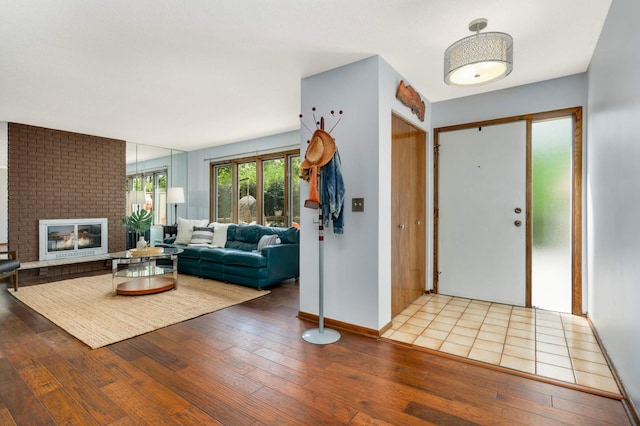 123 Windsor Ct, New Brighton, MN 55112 - foyer entrance with hardwood / wood-style floors, a fireplace, and baseboards
