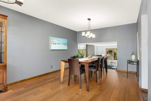 123 Windsor Ct, New Brighton, MN 55112 - dining space with light wood-style flooring, a chandelier, and baseboards