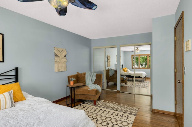 123 Windsor Ct, New Brighton, MN 55112 - bedroom featuring two closets, wood finished floors, baseboards, and a ceiling fan