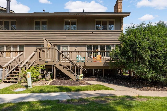 123 Windsor Ct, New Brighton, MN 55112 - rear view of house featuring stairway, a chimney, and a wooden deck