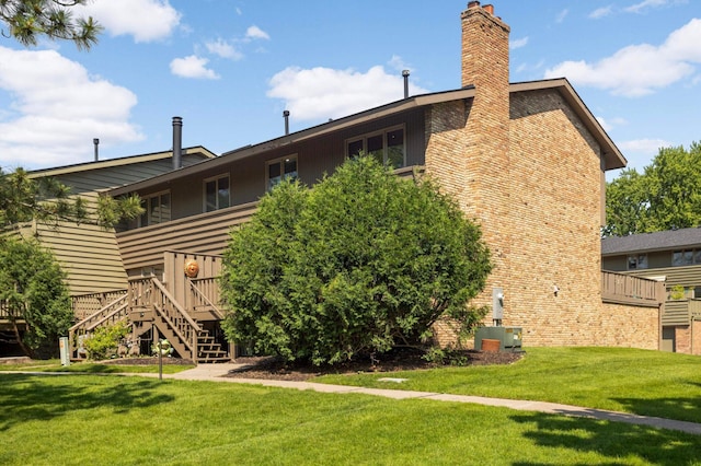 123 Windsor Ct, New Brighton, MN 55112 - rear view of house with stairway, a chimney, a yard, and a deck