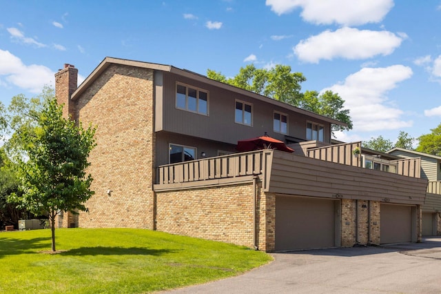 123 Windsor Ct, New Brighton, MN 55112 - rear view of house with a balcony, brick siding, a lawn, and a chimney