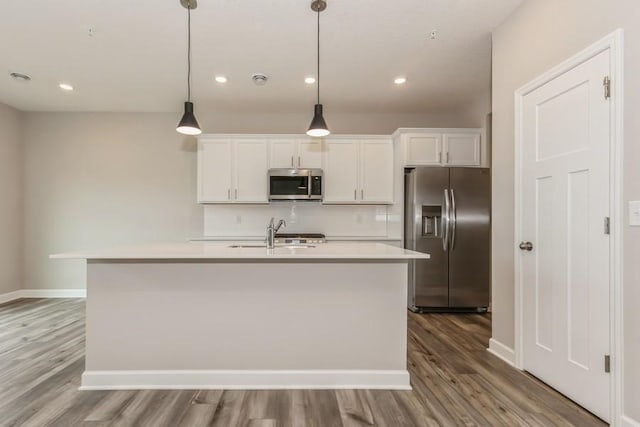 20025 62nd Pl, Corcoran, MN 55340 - kitchen featuring appliances with stainless steel finishes, wood finished floors, light countertops, and recessed lighting
