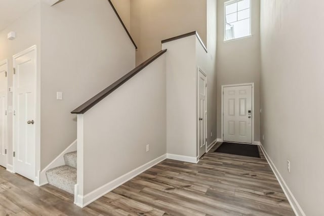 20025 62nd Pl, Corcoran, MN 55340 - entryway with a towering ceiling, stairway, wood finished floors, and baseboards