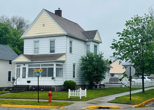 789 5th St, Winona, MN 55987 - view of front facade featuring roof with shingles, a front lawn, and a chimney