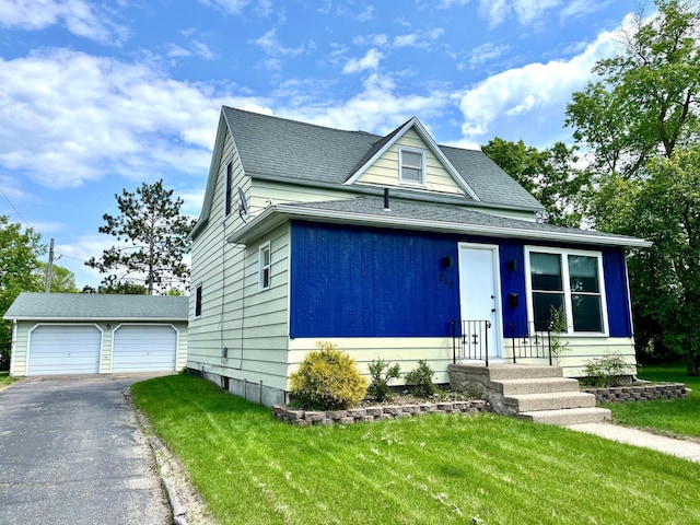 213 Lake Ave, Detroit Lakes, MN 56501 - view of front of home featuring a front yard, an outbuilding, and roof with shingles