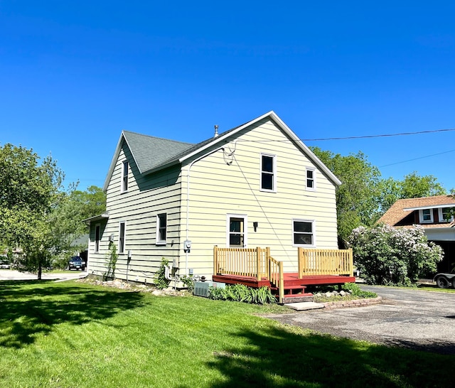 213 Lake Ave, Detroit Lakes, MN 56501 - rear view of house featuring a yard and a wooden deck