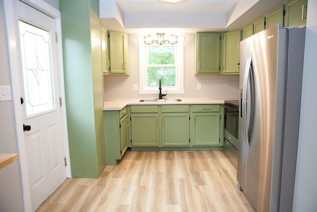 213 Lake Ave, Detroit Lakes, MN 56501 - kitchen with stainless steel fridge with ice dispenser, green cabinets, a sink, a chandelier, and light wood-style floors