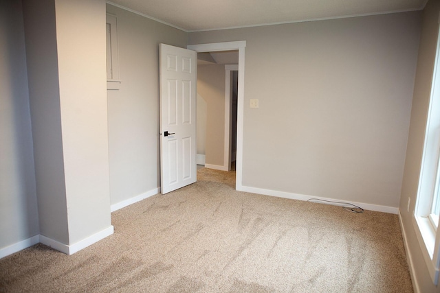 213 Lake Ave, Detroit Lakes, MN 56501 - unfurnished bedroom featuring carpet floors, ornamental molding, and baseboards