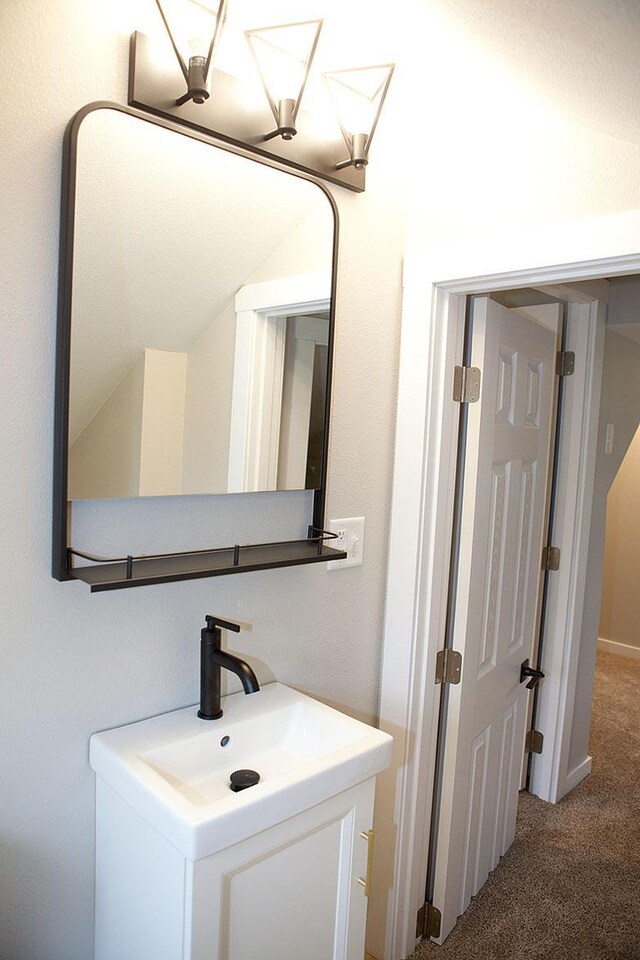213 Lake Ave, Detroit Lakes, MN 56501 - bathroom with vanity and vaulted ceiling