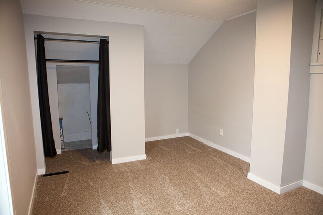 213 Lake Ave, Detroit Lakes, MN 56501 - unfurnished bedroom with carpet floors, lofted ceiling, and baseboards