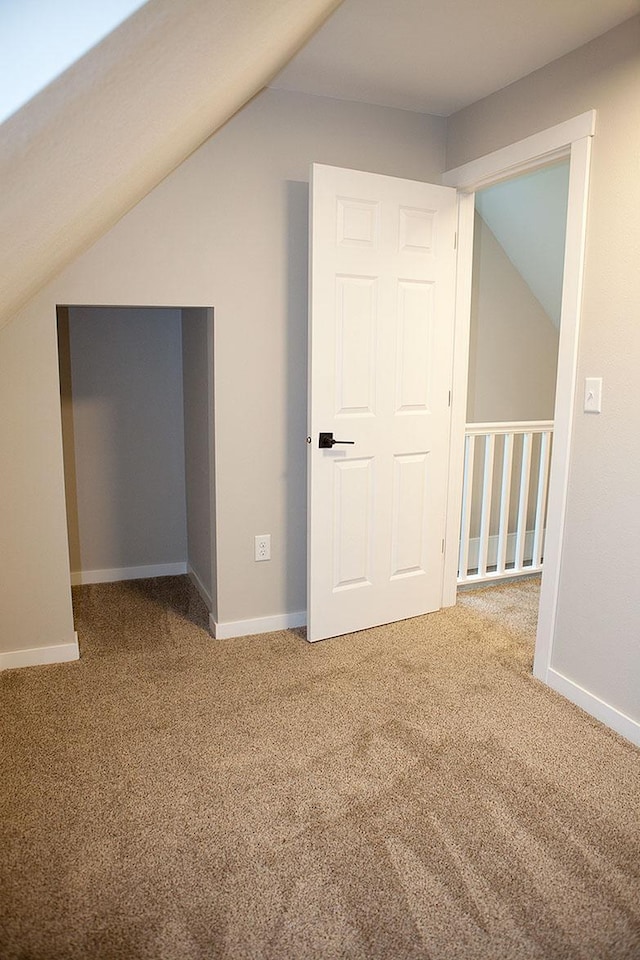 213 Lake Ave, Detroit Lakes, MN 56501 - additional living space with vaulted ceiling, carpet, and baseboards