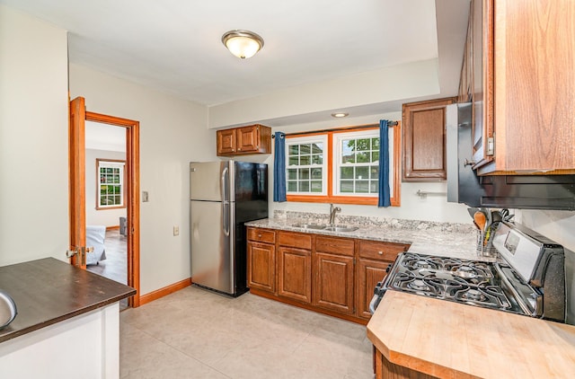 5805 Sunrise Dr, Minneapolis, MN 55419 - kitchen featuring stainless steel appliances, brown cabinetry, and light tile patterned floors