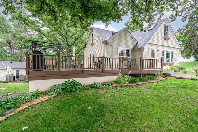 5805 Sunrise Dr, Minneapolis, MN 55419 - back of house featuring a wooden deck, a lawn, and a shingled roof