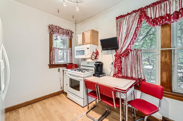 1107 Edmund Ave, Saint Paul, MN 55104 - kitchen featuring white appliances, light wood finished floors, and an office area
