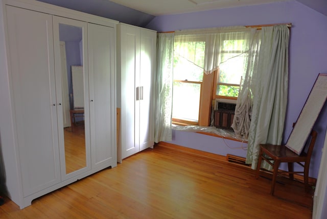 1107 Edmund Ave, Saint Paul, MN 55104 - unfurnished room featuring light wood-type flooring and vaulted ceiling