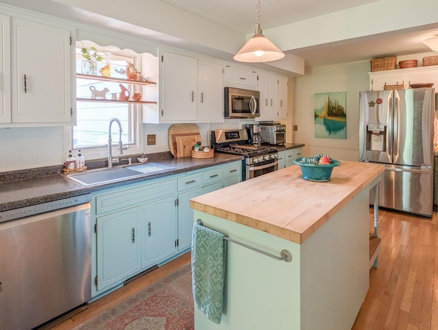 3466 Yukon Ave N, New Hope, MN 55427 - kitchen featuring stainless steel appliances, wood counters, blue cabinetry, light wood-style flooring, and a center island