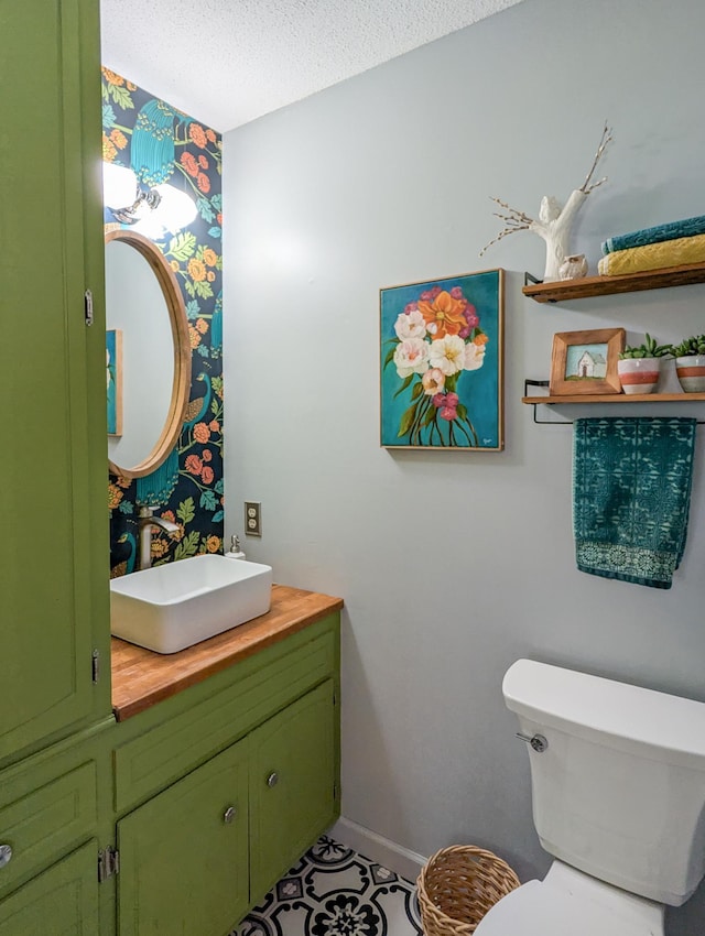 3466 Yukon Ave N, New Hope, MN 55427 - half bath featuring vanity, a textured ceiling, and wallpapered walls