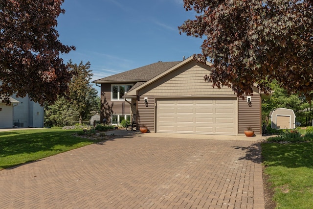 420 Cedar Ct NE, Pine Island, MN 55963 - view of front of house featuring a front yard, decorative driveway, and a garage