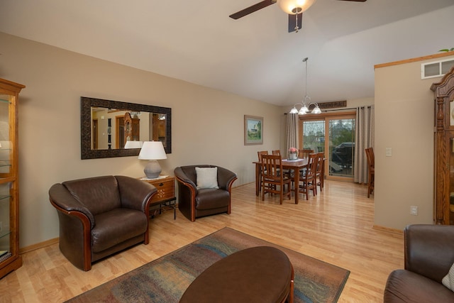 420 Cedar Ct NE, Pine Island, MN 55963 - living area featuring light wood-type flooring, lofted ceiling, a chandelier, a ceiling fan, and baseboards